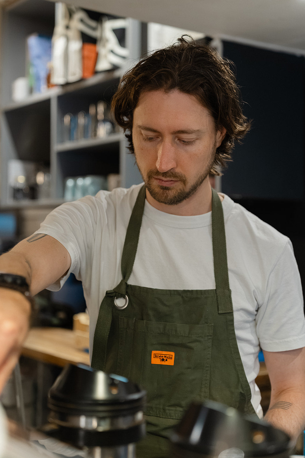 Barista preparing espresso behind the counter at Bond Street Coffee in Brighton.