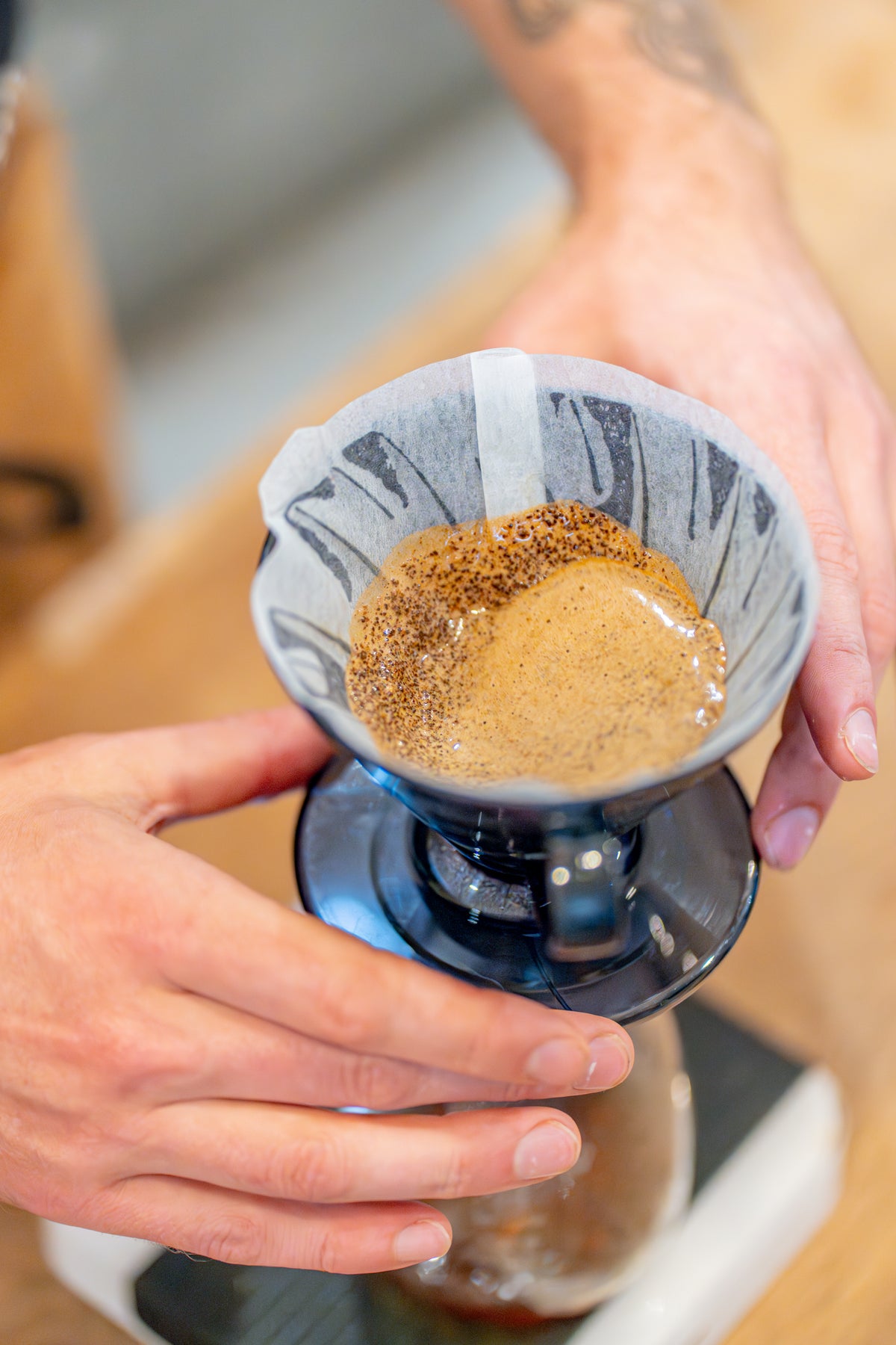 Founder of freda-coffee.live using a Rao Spin to evenly distribute speciality coffee grounds in a Hario V60